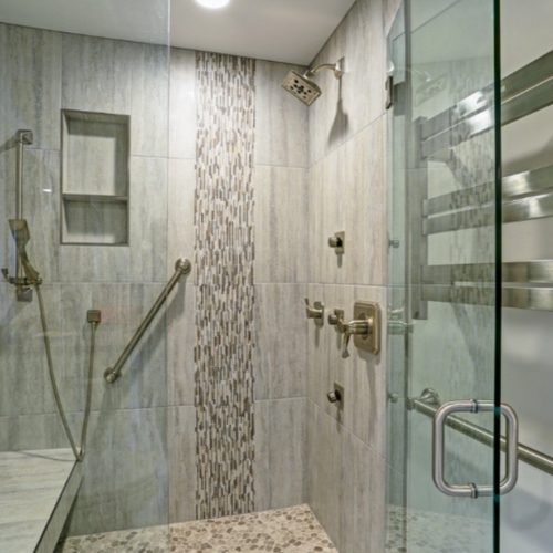 Accessible shower with patterned tiles, seat and safety bars