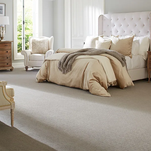 Cozy Glendale AZ bedroom with neutral carpet flooring