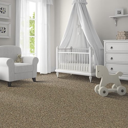Beige carpet flooring in a nursery with white furniture