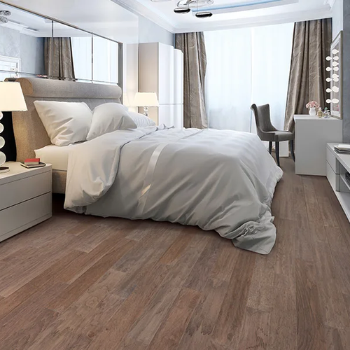 Cozy bedroom in an Arizona home with wood flooring